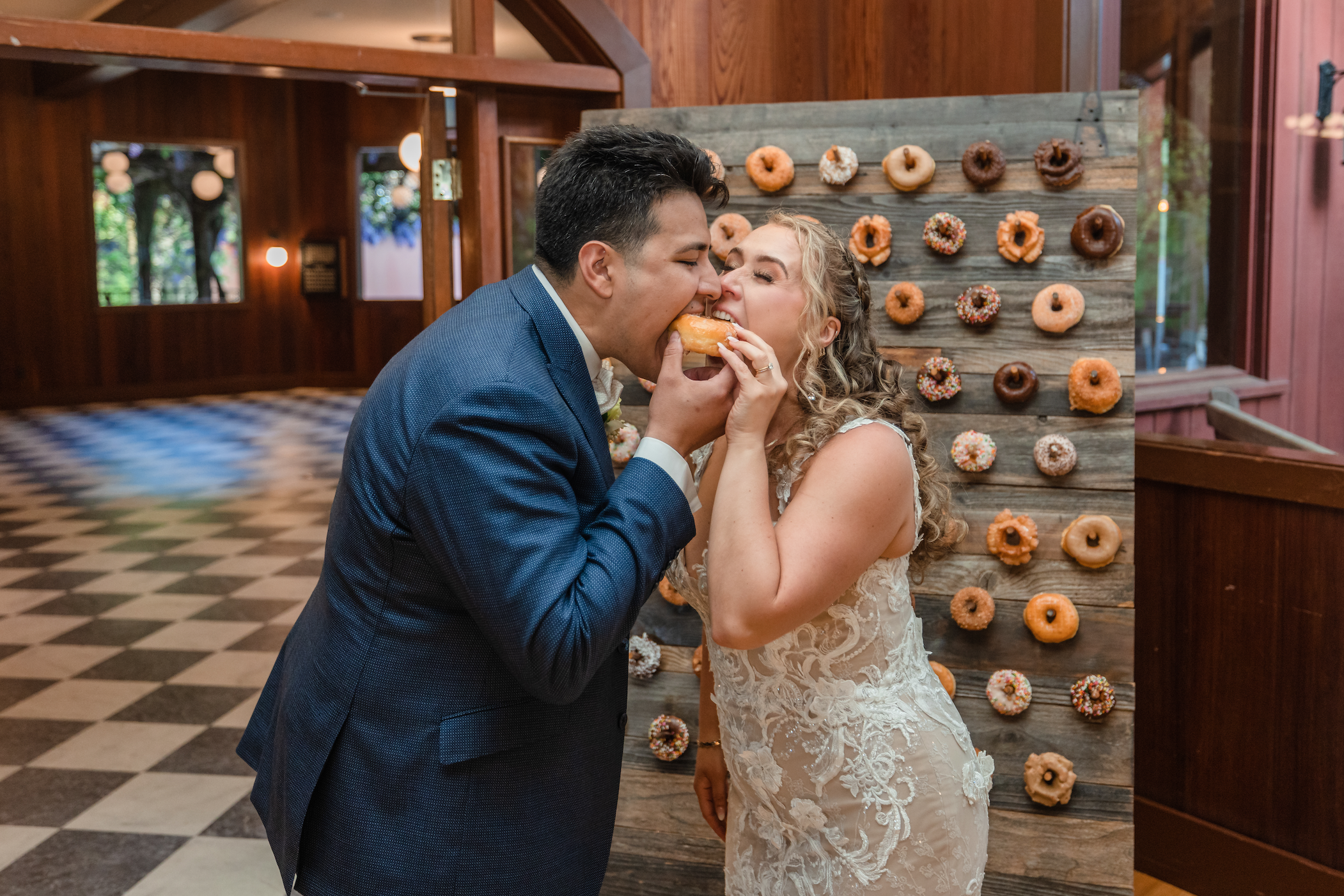 Couple eating a donut instead of the traditional cake cutting moment